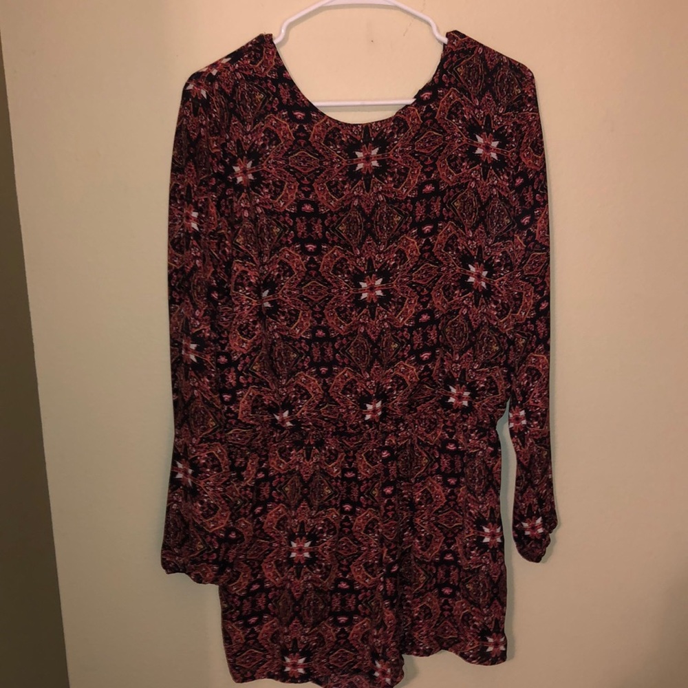 Long sleeves patterned romper with open back. Size large.